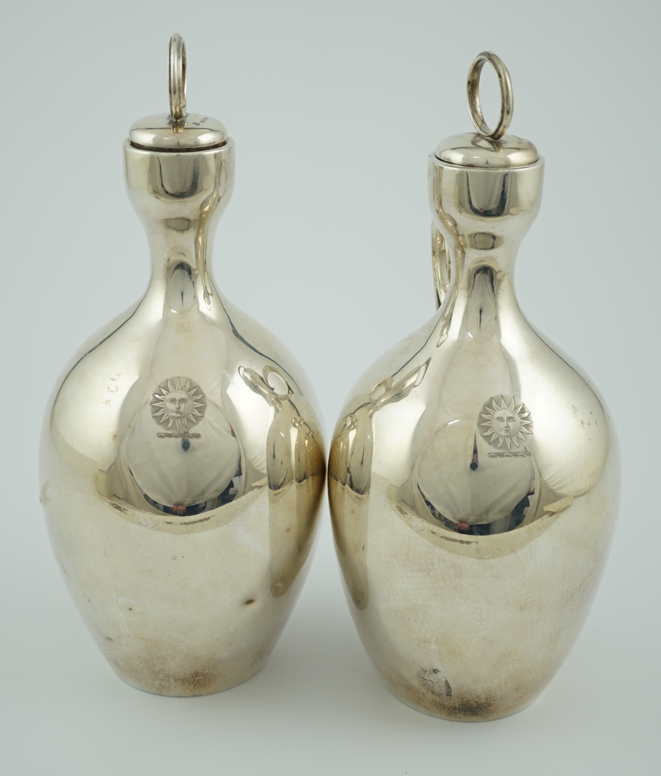 A pair of Victorian silver single handled ovoid water/wine jugs with stoppers, by R & S Garrard & Co